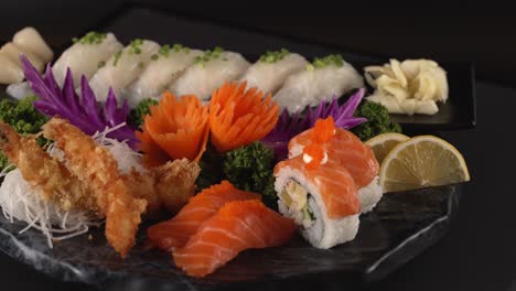 an elegantly curated selection of salmon sushi rolls, white fish sashimi, and crispy shrimp tempura. 세련되게 담긴 연어 스시 롤, 흰살 생선 사시미, 바삭한 새우튀김.