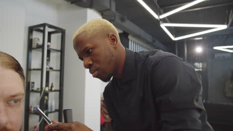 Afro-American-Hairdresser-Working-with-Client-in-Barbershop