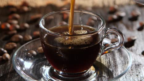 vertiendo café en una taza de vidrio