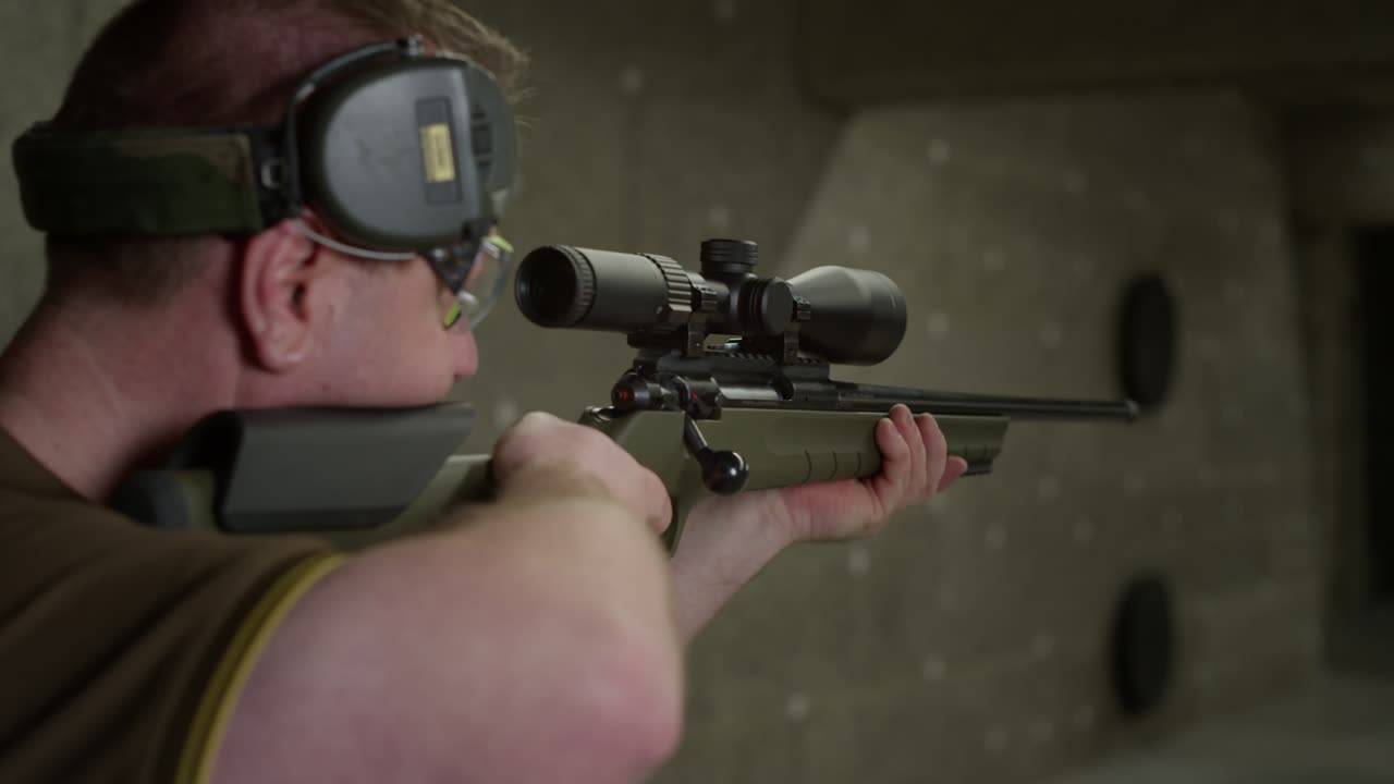 Man Aiming Hunting Sniper Rifle Reloads with Empty Bullet Shell Falling Flying out from side view