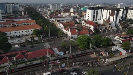 aerial footage, dense atmosphere of malioboro street yogyakarta, visible railway tracks of tugu station. main destination in yogyakarta.