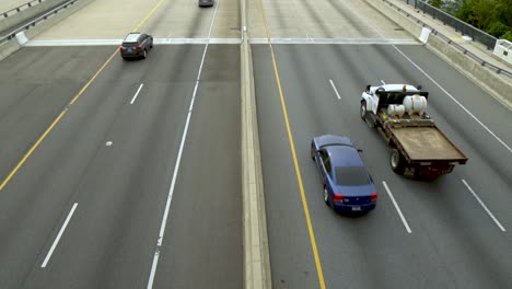 Vehicles-driving-over-the-Woodrow-Wilson-Bridge-and-Potomac-River-between-Maryland-and-Virginia-on-a-cloudy-day-in-slow-motion-from-overpass-away-from-camera