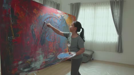 girl painting abstract art in a home studio