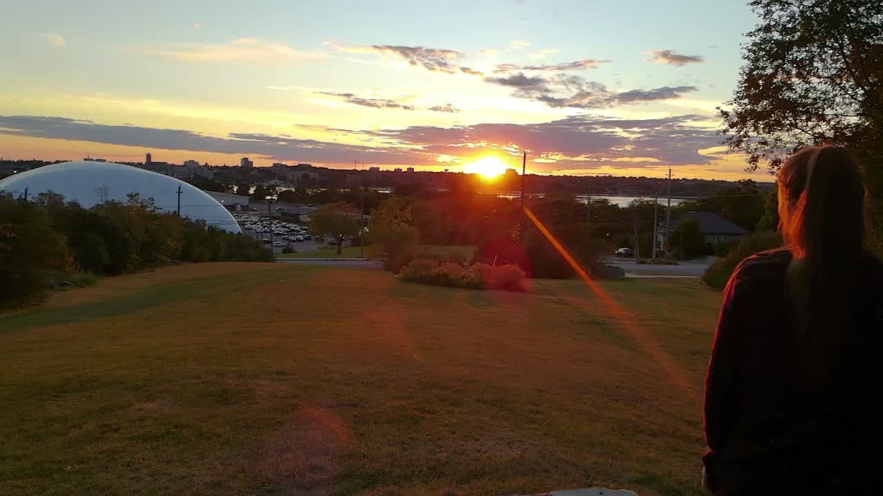 women over looking a city during fall Sunset