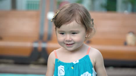 happy active little toddler having fun dancing and jumping at an outdoor playground