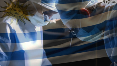 Animation-of-flag-of-uruguay-over-surgeons-in-operating-theatre