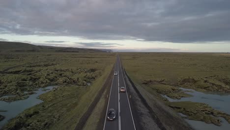 drone footage flying over a road in iceland