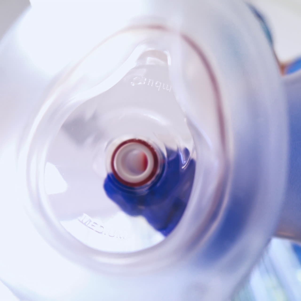 Close-up medical tool for breathing on the blurred background. Doctor puts on patient's face special mask in the emergency room.