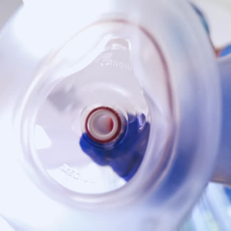 close-up medical tool for breathing on the blurred background. doctor puts on patient's face special mask in the emergency room.