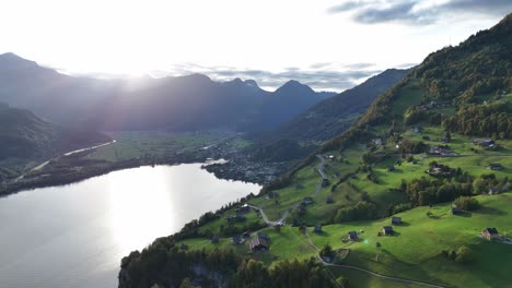 sunset over timeless swiss landscape overlooking mirror-like lake nestled in valley