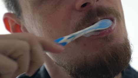 close up tight shot of a man brushing teeth, detail