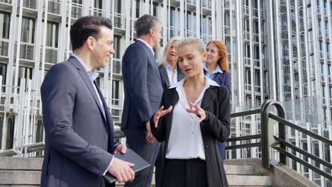business professionals conversing outdoors in a city environment