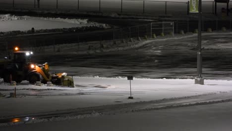 Tractor-cleaning-snow-on-public-roads-at-night,-after-snowfall-in-the-city-of-Toronto,-Canada