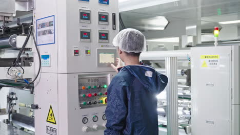 production workshop, technicians engineer setting and programing to start cnc machine in the manufacturing. male worker working and maintaining machine in the industrial factory