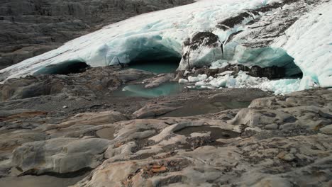 traveler on lookout to ice caves and glacier, high mountains alpine enviroment, new zealand - drone aerial close up