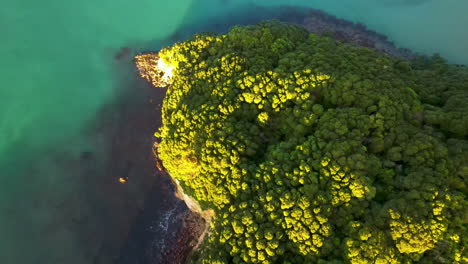 Aerial-reveal-of-Whangamata-township-and-coastal-scenery-of-New-Zealand-during-sunset