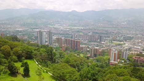 aerial panorama shot of hills and buildings in city center medellin, mirador palmas