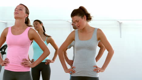 fit women doing yoga together in studio