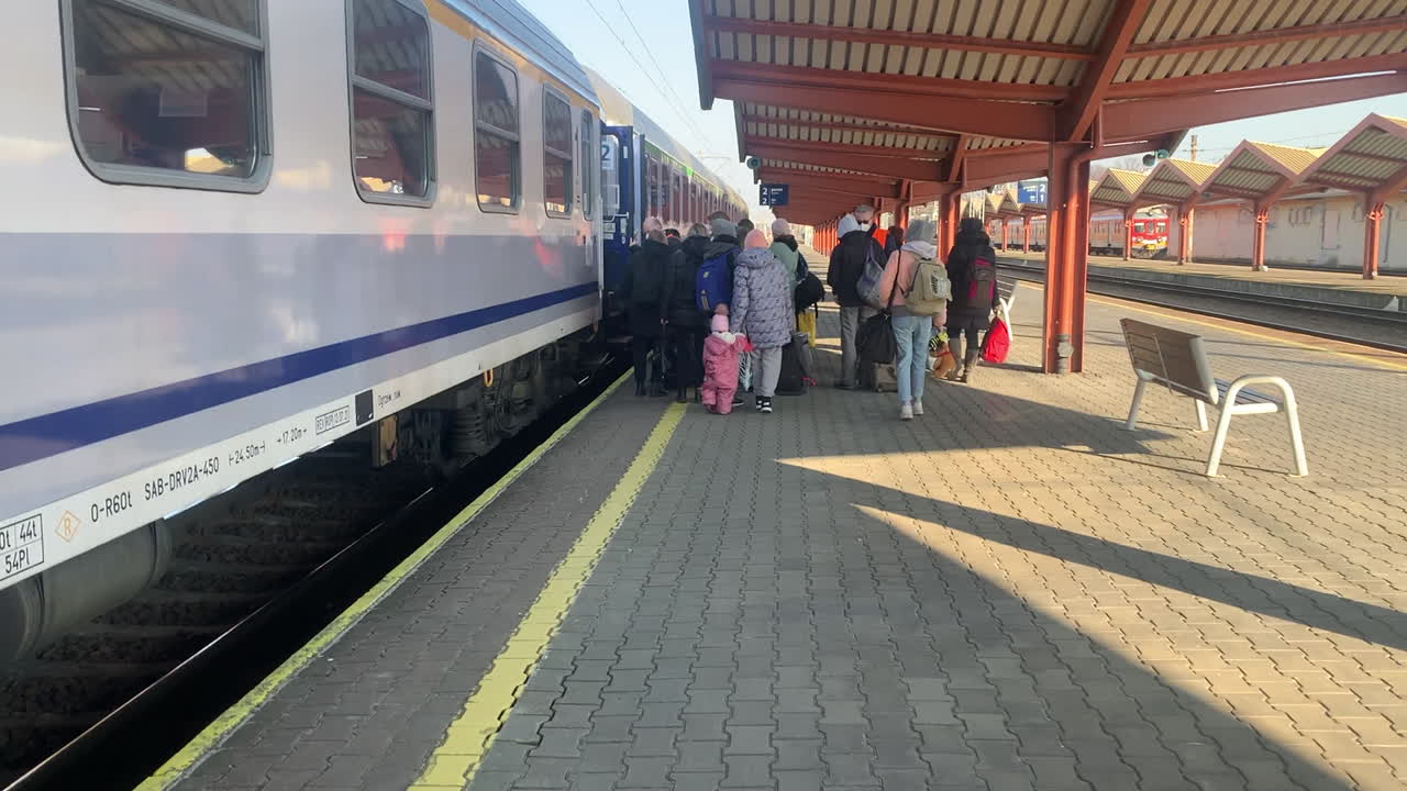 Ukrainian refugees boarding a train to escape the conflict with Russia