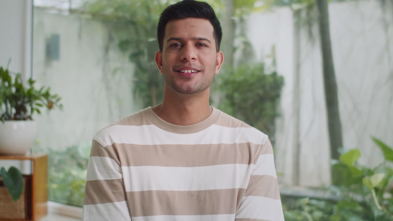 Portrait of Cheerful Male Yogi Meditating on Floor