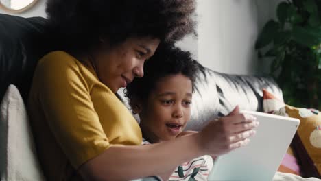 two children browsing digital tablet in the living room