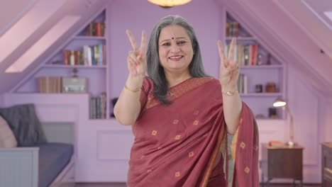 Happy-Indian-old-woman-showing-victory-sign