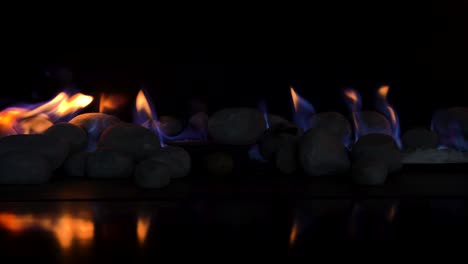 flames-ignite-on-round-river-stones