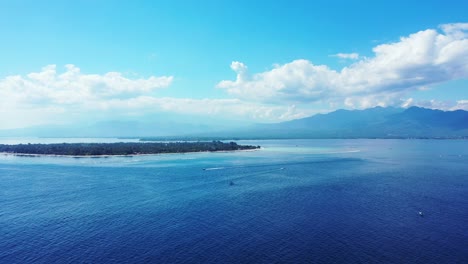 fiji island surrounded by the deep blue ocean under the bright blue sky - aerial shot