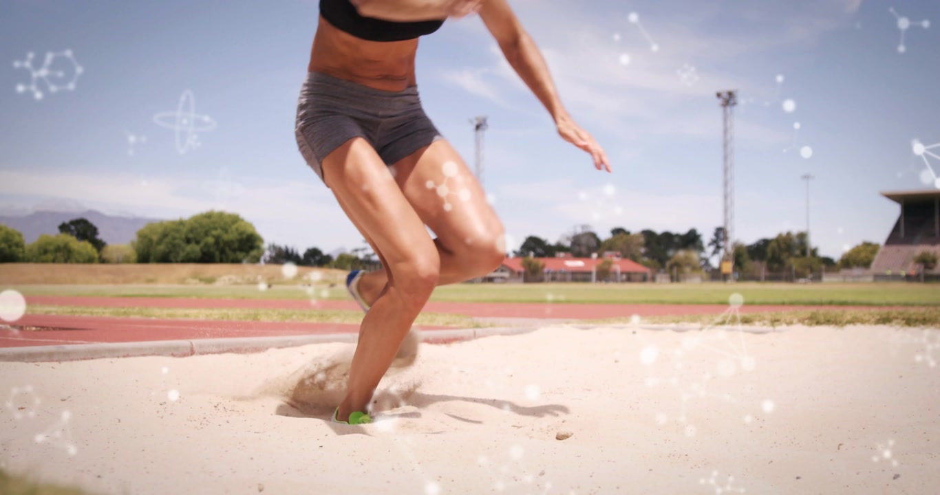 Female athlete taking off, clearing sand pit and landing, scattering sand with sparkle overlay