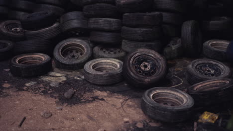 pile of used tires and wheels