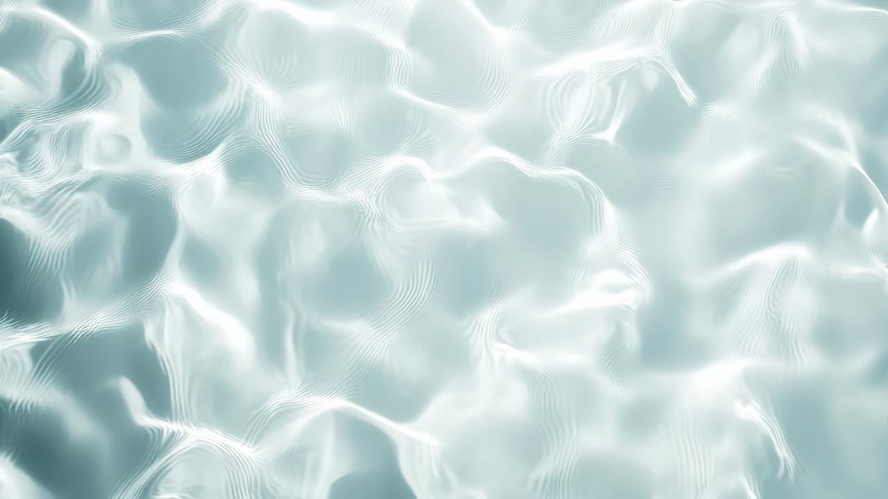Top-down video shot of shimmering water surface, capturing gentle ripples and light reflections