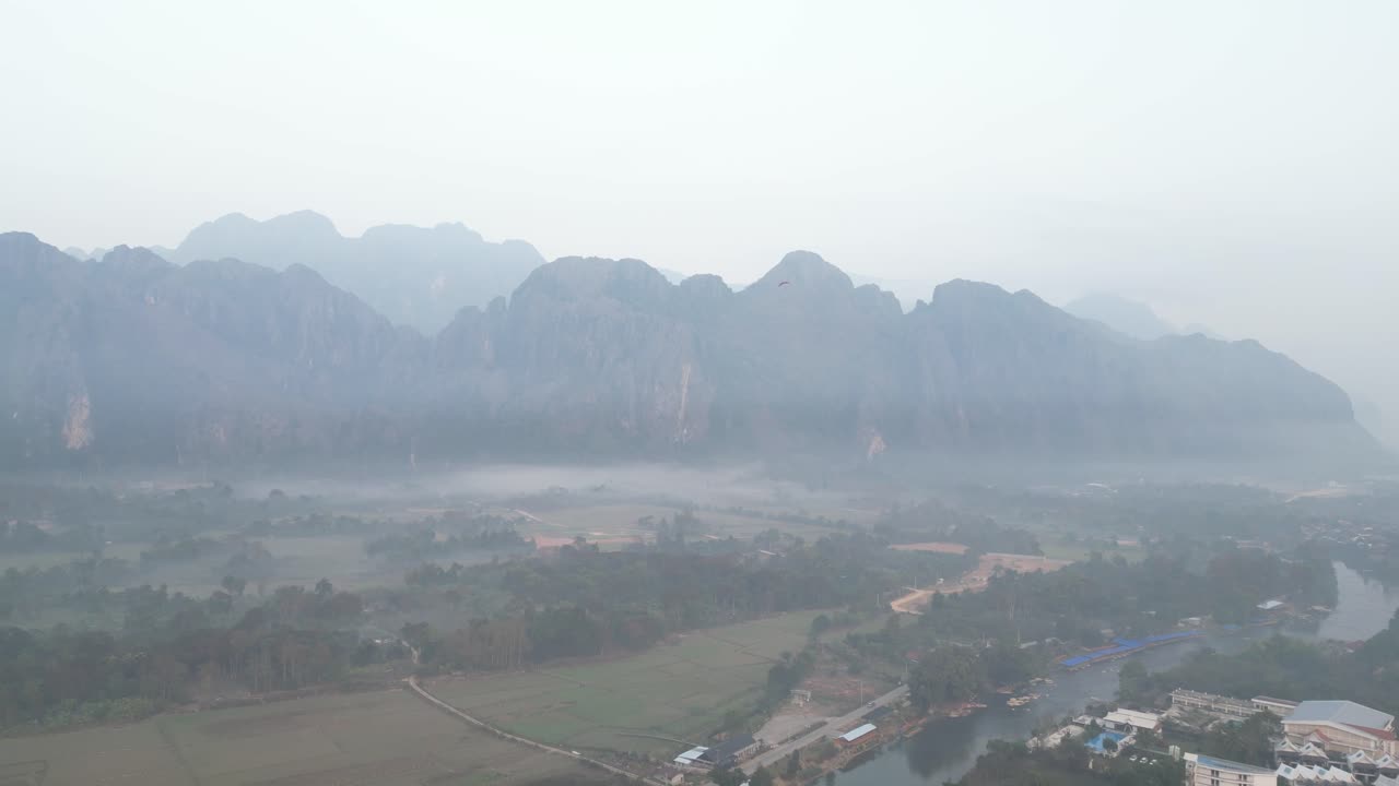 drone shot of foggy valley in Vang Vieng, the adventure capital of Laos