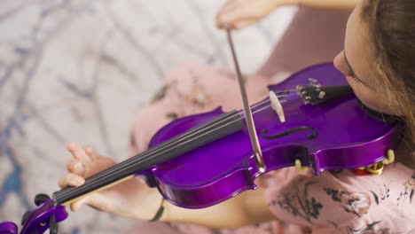 close-up of musician woman playing violin at home. composing, playing music.