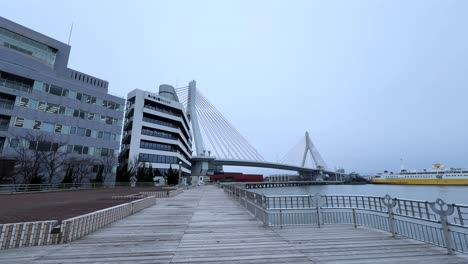 Bridge and harbor promenade at Aomori Bay with quiet morning mood, overcast sky