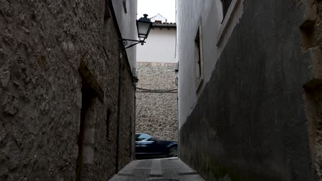cuenca, spain - a view down a medieval stone alley in the historic heart of this unesco city. the old, textured walls evoke a sense of history and mystery.