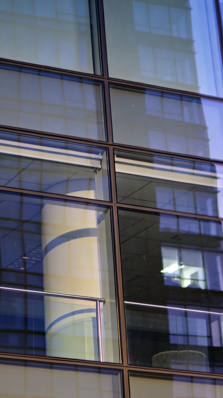 Close-up of Modern Glass Building Facade with Reflections