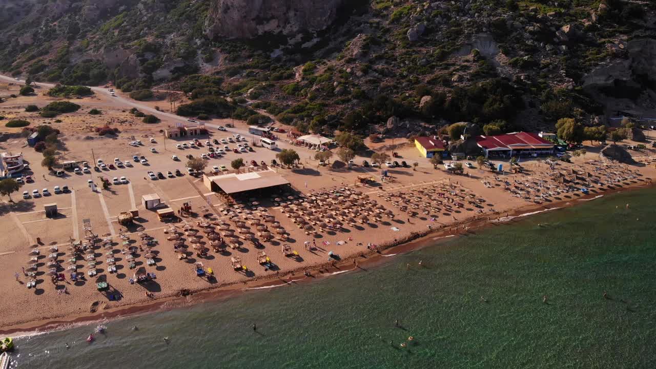 Aerial View Of Broad Unspoiled Tsambika Beach With Sun Loungers And Umbrellas On Rhodes Island In Greece