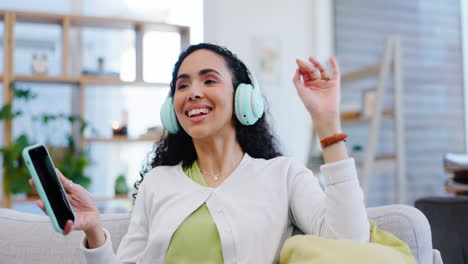 Headphones,-dancing-and-woman-on-a-sofa