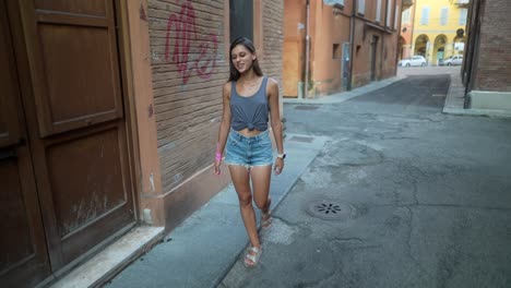 young woman walking in a city alley