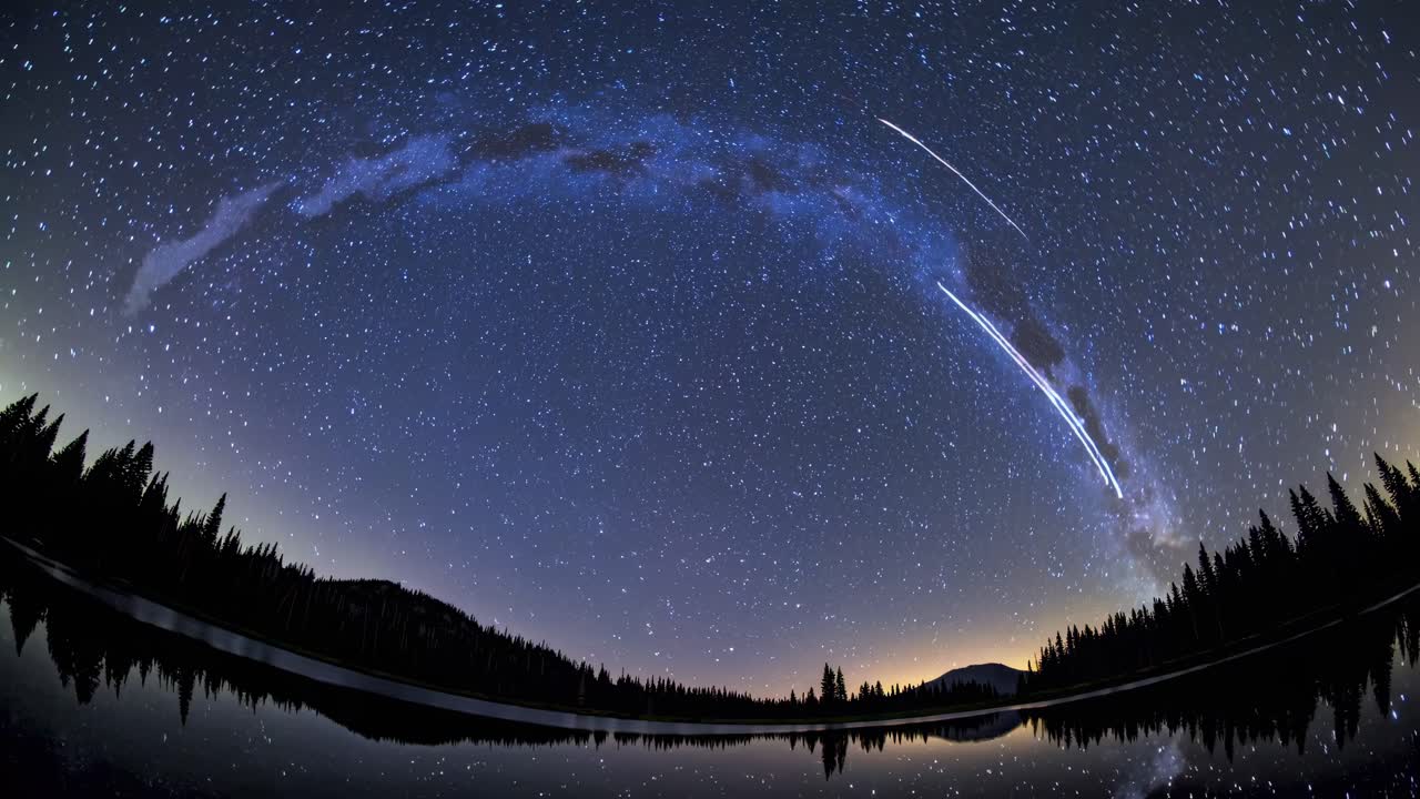 A stunning time-lapse video captures a fisheye view of the night sky, showcasing a starry arc