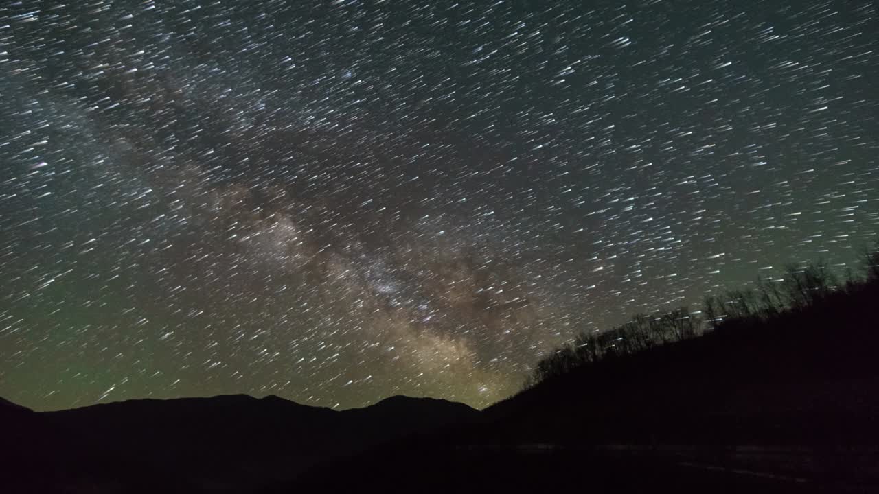 은하계는 알바니아의 오섬 강에서 산의 실루 위에 별의 흔적과 함께 움직입니다.