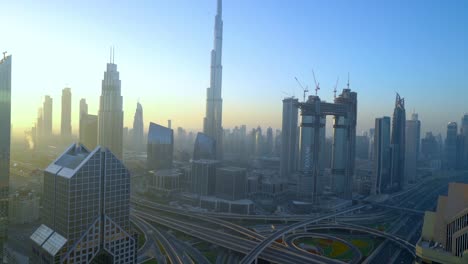 Dubai-Skyline-With-The-Famous-Burj-Khalifa-And-Sheikh-Zayed-Road-From-The-Rooftop-of-Shangri-la-Hotel-At-Sunrise-In-Dubai,-UAE