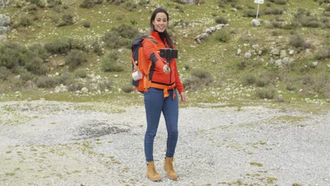 Smiling-young-backpacker-using-a-selfie-stick