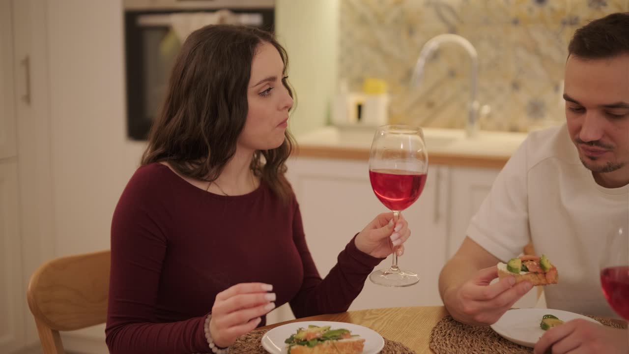 una pareja enamorada haciendo un sándwich en la cocina de la sala de estar