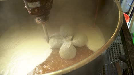 adding the hop to the beer wort when boiling the mash in the brew kettle