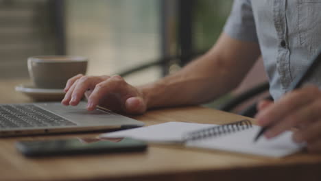 businessman-holding-pen-writing-new-appointments-information-in-organizer-concept-mixed-race-male-hands-making-notes-in-personal-paper-planner-at-desk-Learn-about-the-stock-and-investment-market