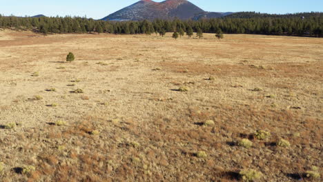 dry deserted land around steep cinder cone volcanic lava mountain