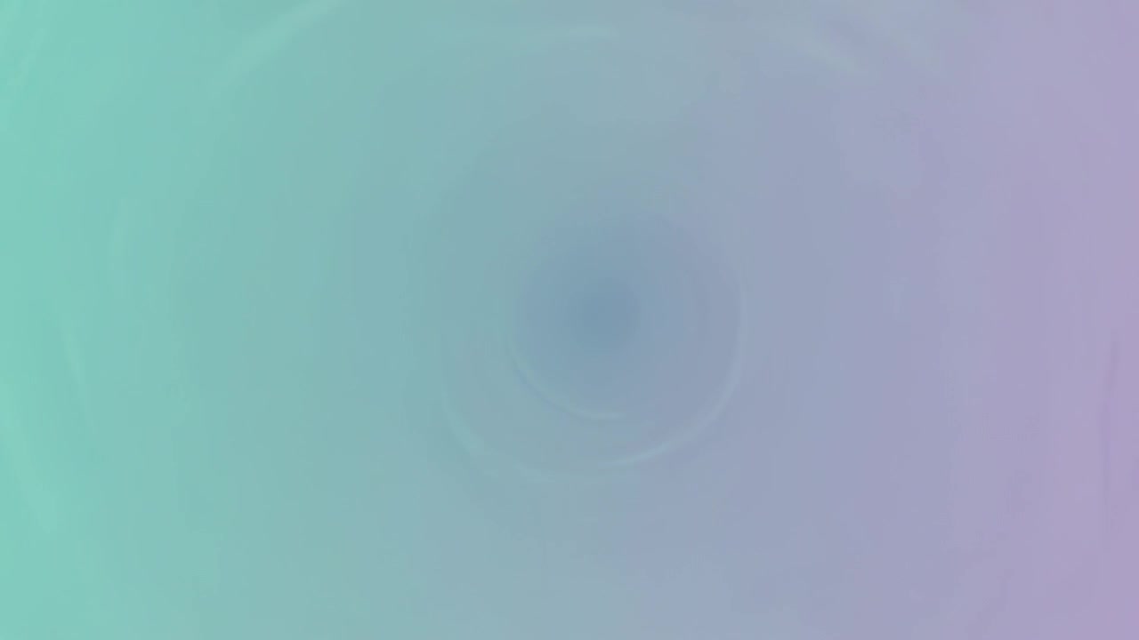 Pulsing central ripple showing darker spot during animation playback forming teal-lavender vignette