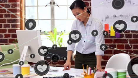 animation of network of connections with heart icons over biracial businesswoman in office