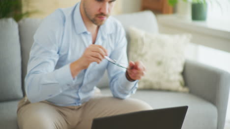 Modern-Businessman-Opens-Laptop-and-Starts-Working-Remotely